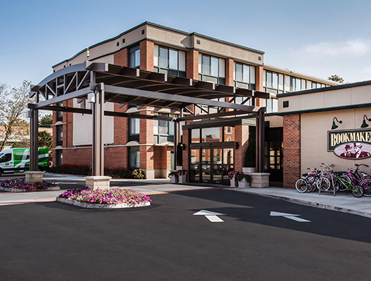 a building with a parking lot and a parking lot