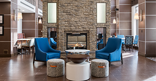 a room with a fireplace and chairs