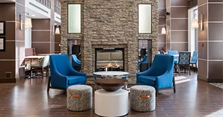 a room with a fireplace and chairs