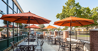a patio with tables and umbrellas