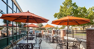 a patio with tables and umbrellas