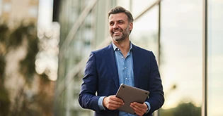 a man in a suit holding a tablet