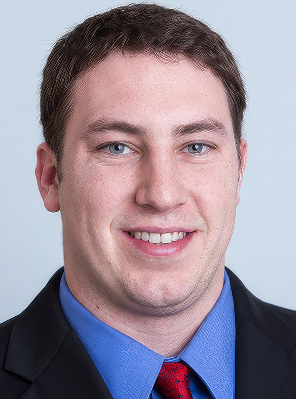 a man in a suit smiling