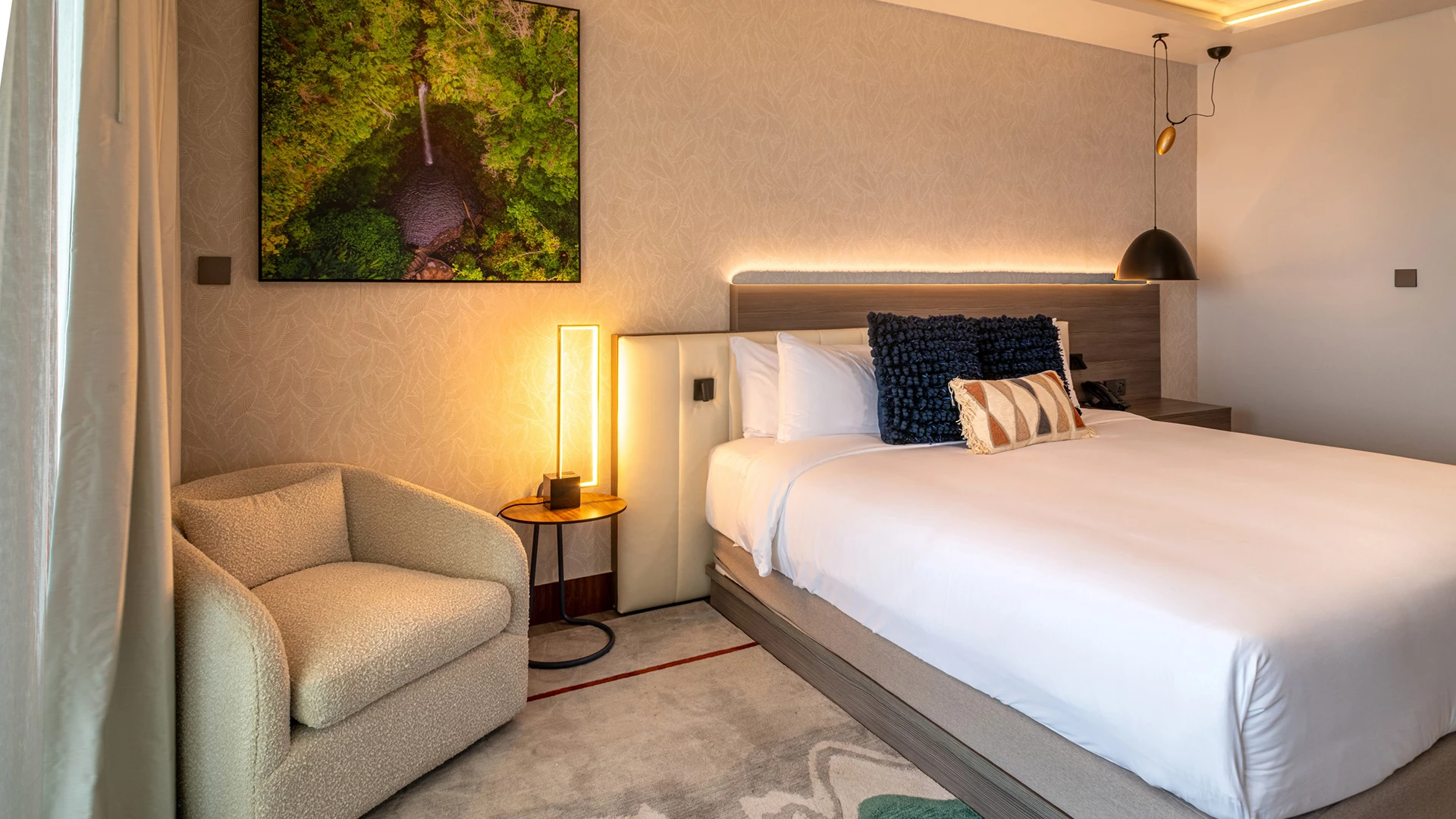 a bed with pillows and a lamp in a room