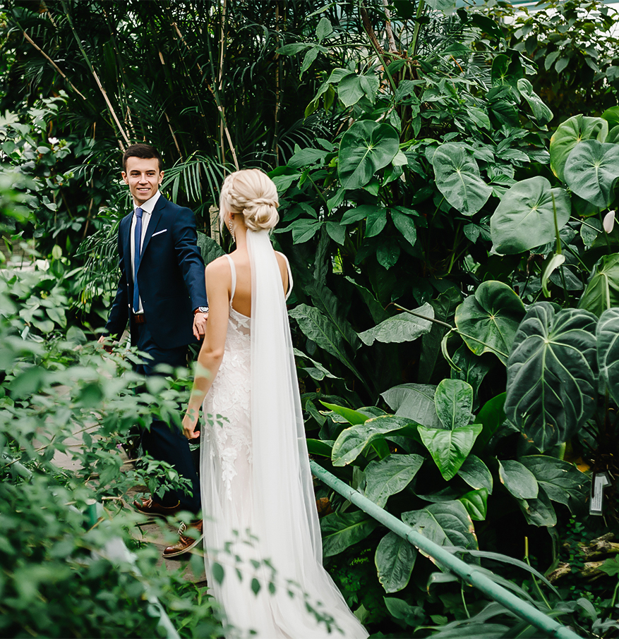 a man and woman walking in a garden