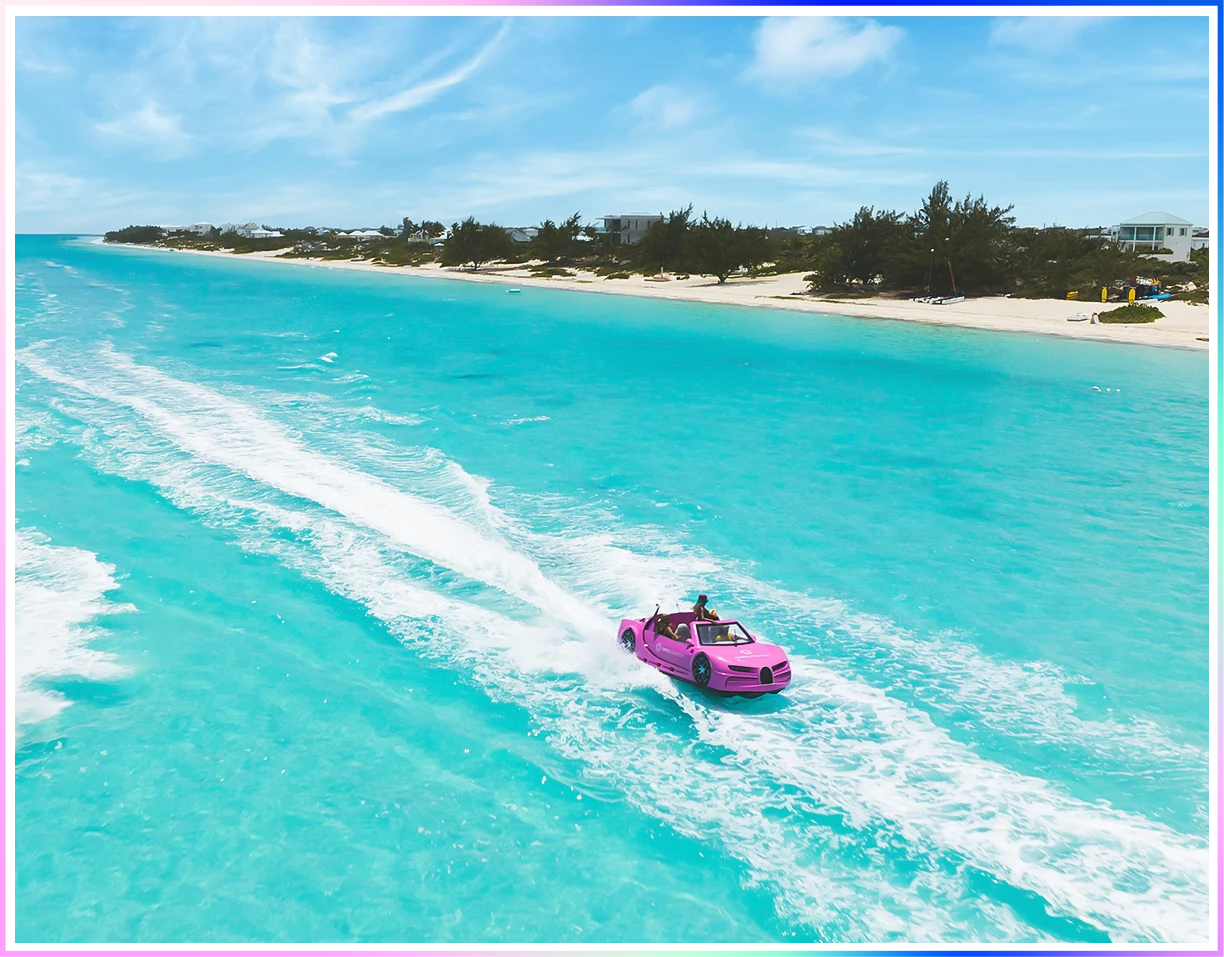 a pink car driving through a body of water