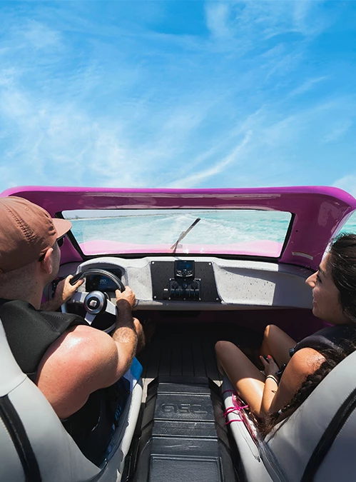 a man and woman driving a boat