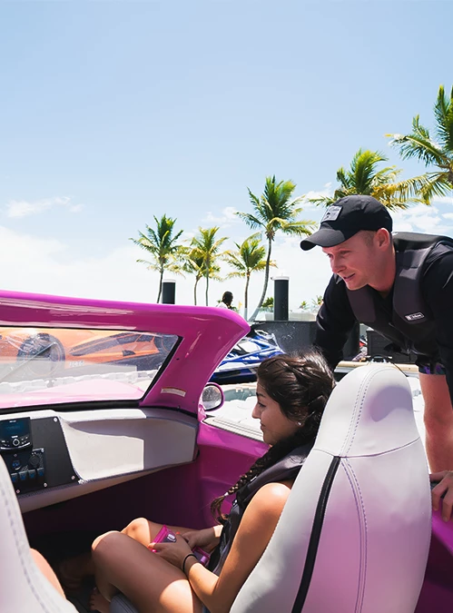 a man standing next to a woman in a pink car