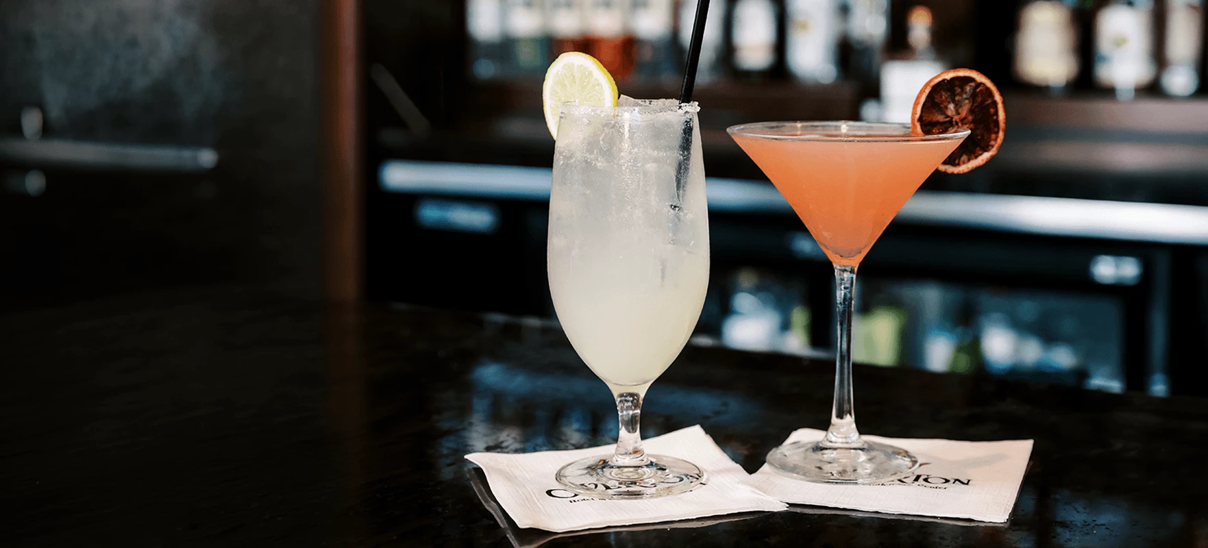 two glasses of drinks on a table