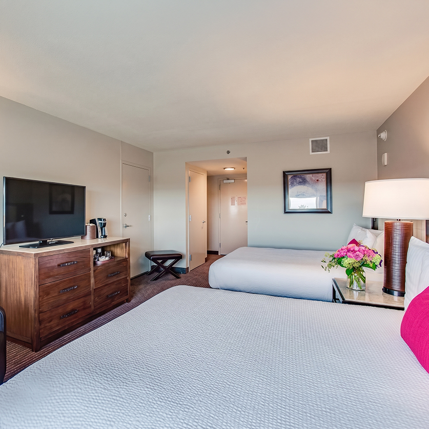 a room with two beds and a television