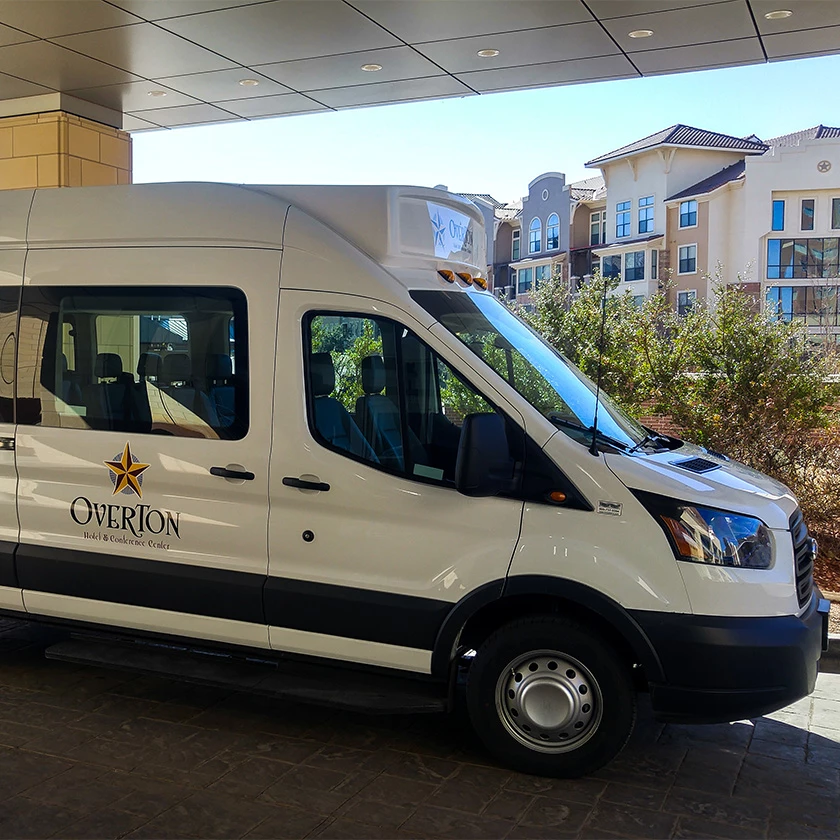 a white van parked under a canopy