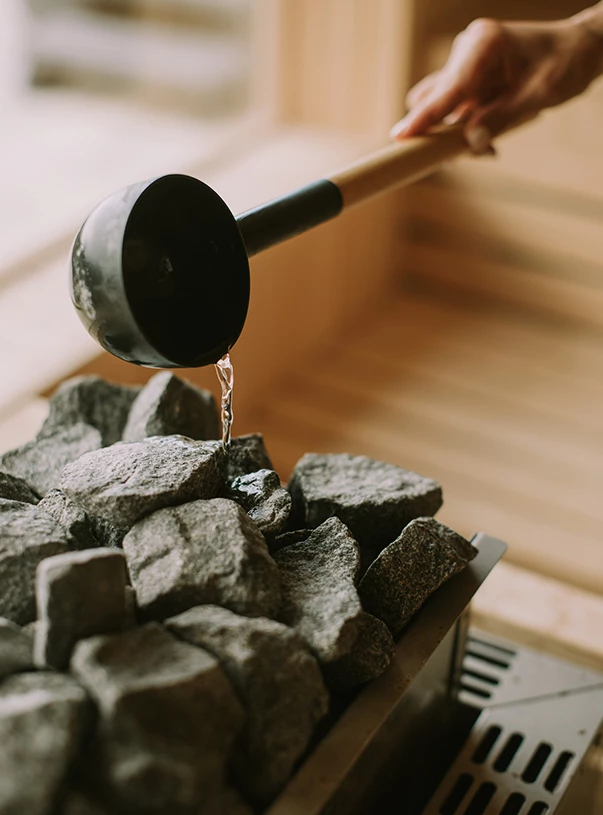 a hand pouring a liquid into a container