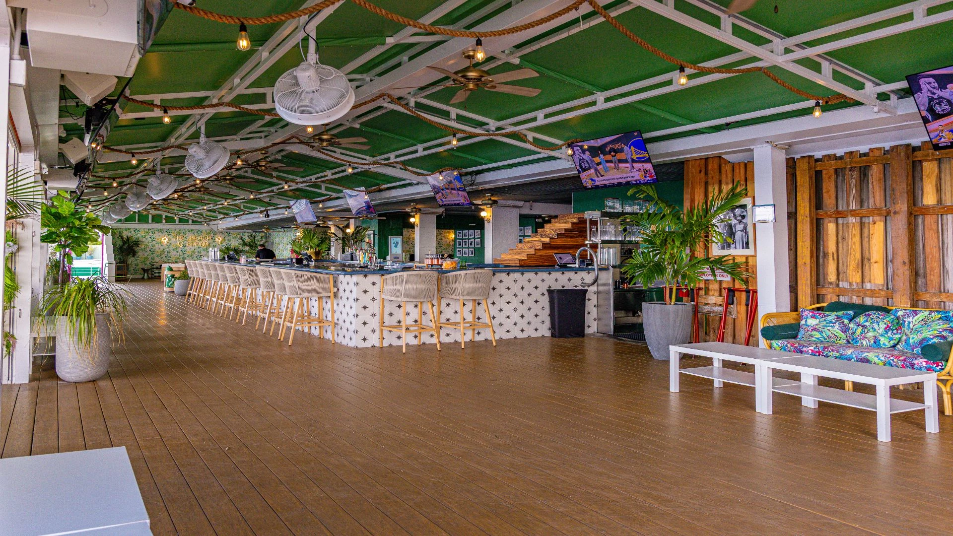 a large bar with chairs and tables in a restaurant