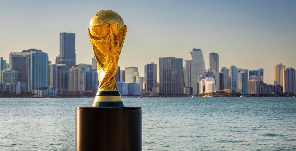 a trophy on a pedestal with a city in the background