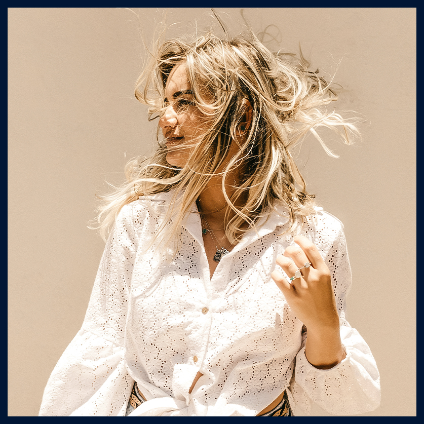 a woman with her hair blowing in the wind