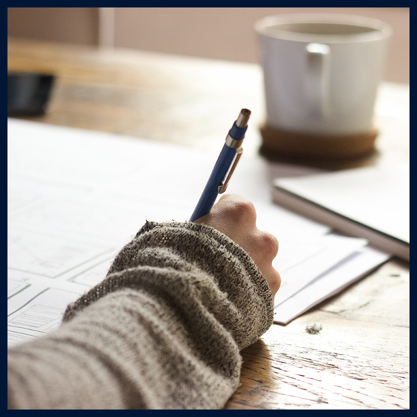 a hand holding a pen