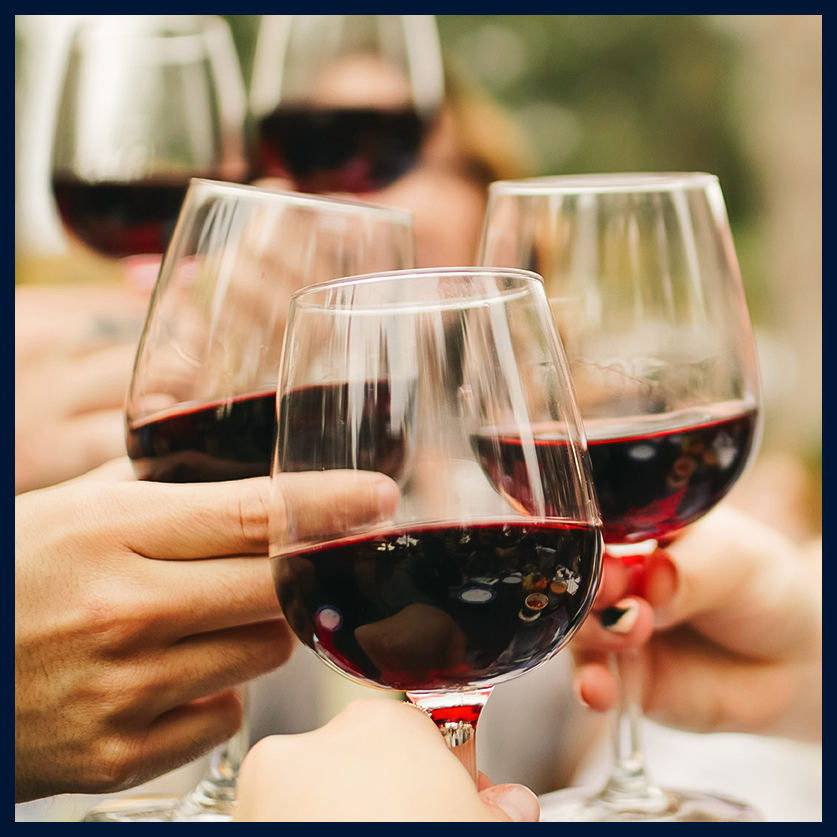 a group of people clinking wine glasses