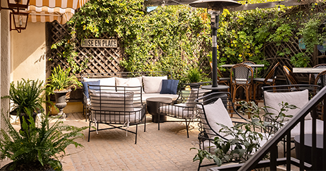 a patio with chairs and a table
