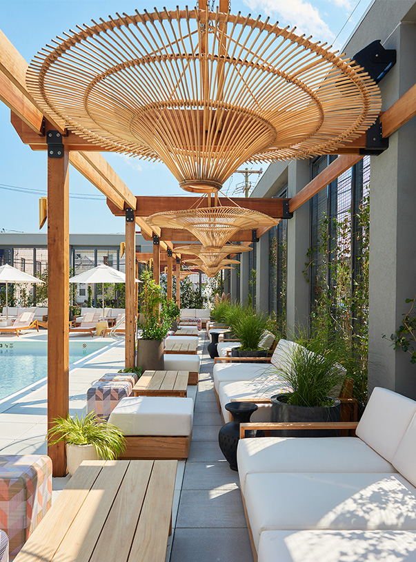 a patio with white couches and umbrellas