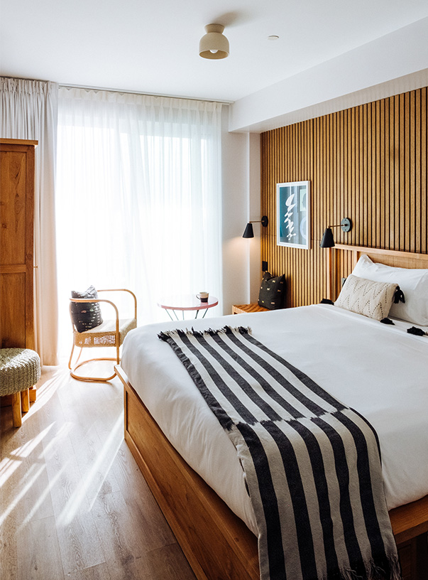 a bed with a striped blanket in a room