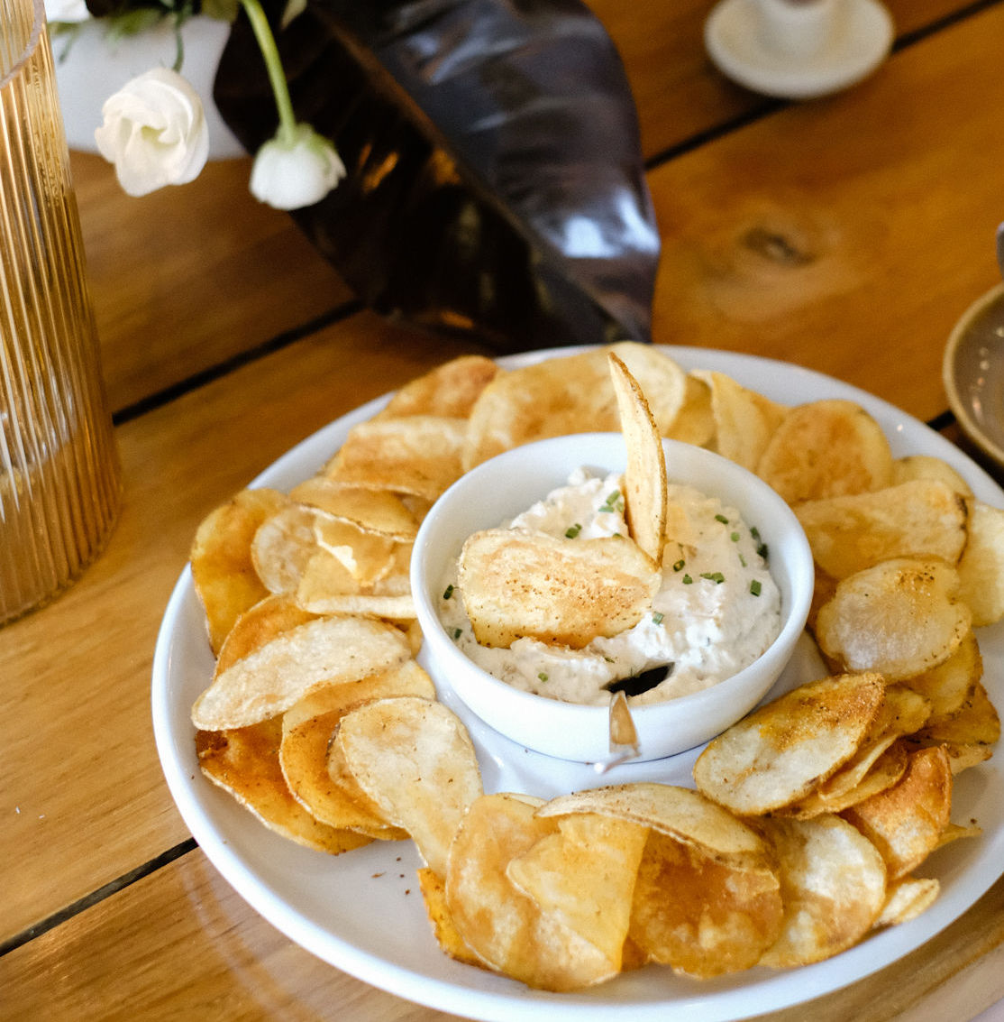 a plate of potato chips and dip