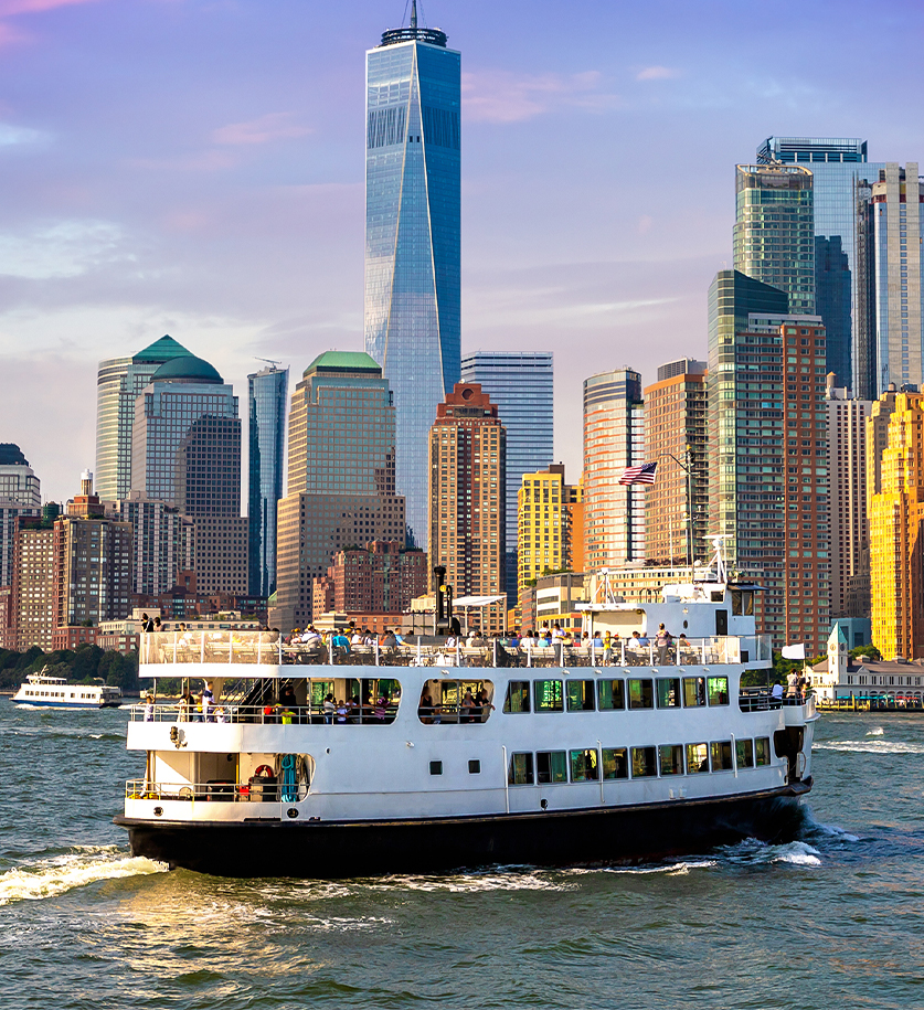 a ferry boat in the water with a city in the background