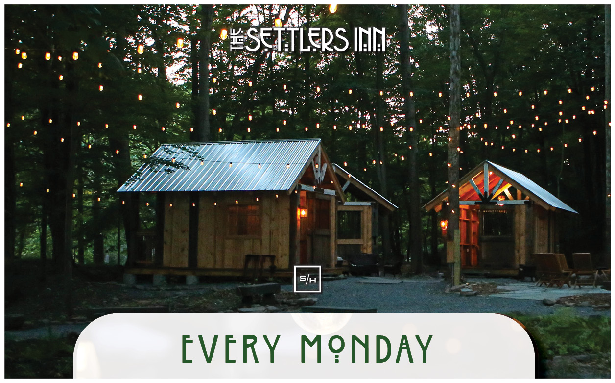 a group of small wooden houses in the woods
