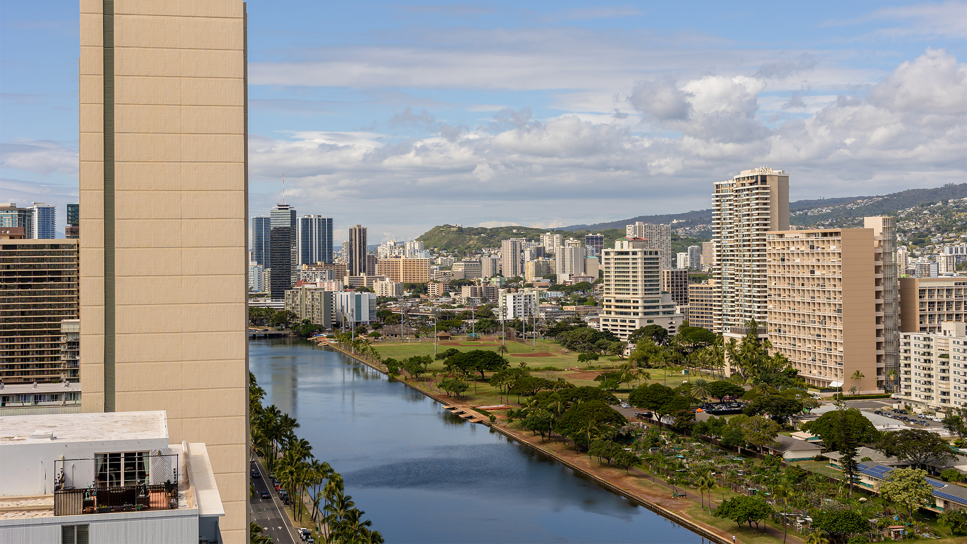 A high-rise building with a city and river view