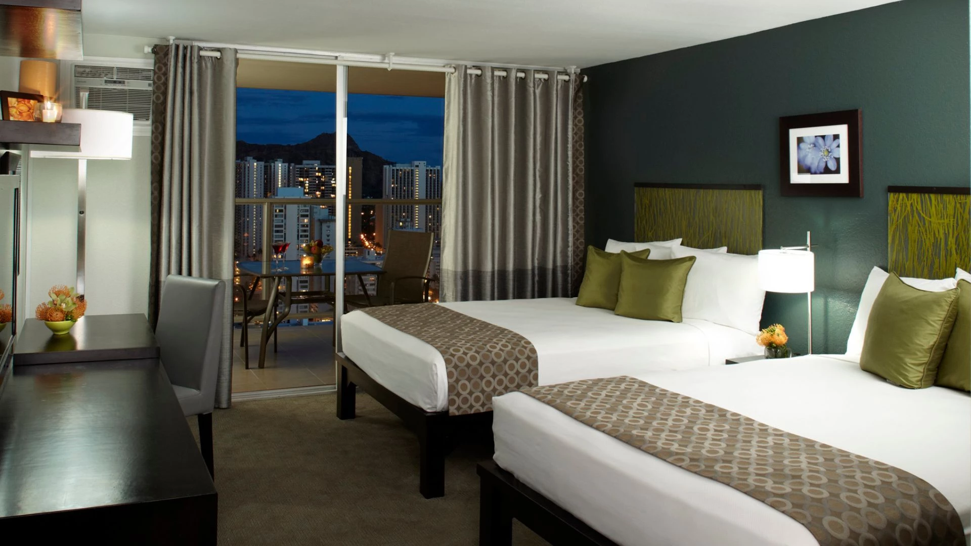 a room with two beds and a glass door