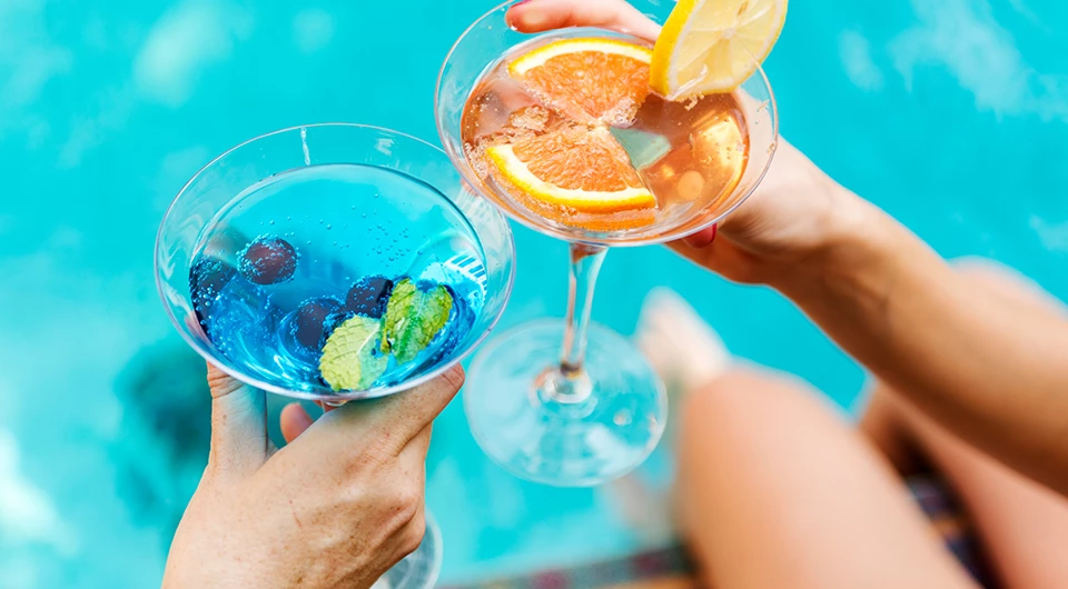 a pair of hands holding drinks
