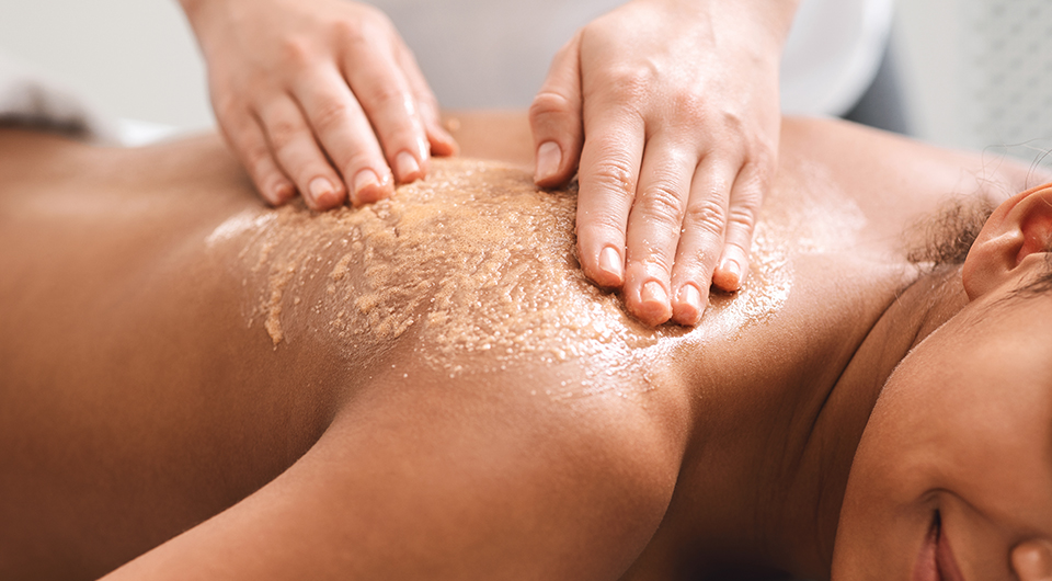 a person receiving a scrub on their back