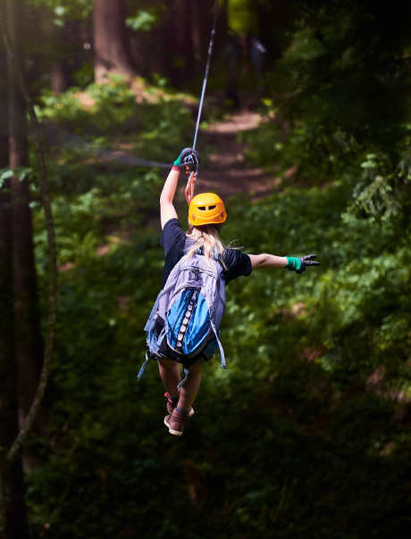 a woman wearing a helmet and holding a rope