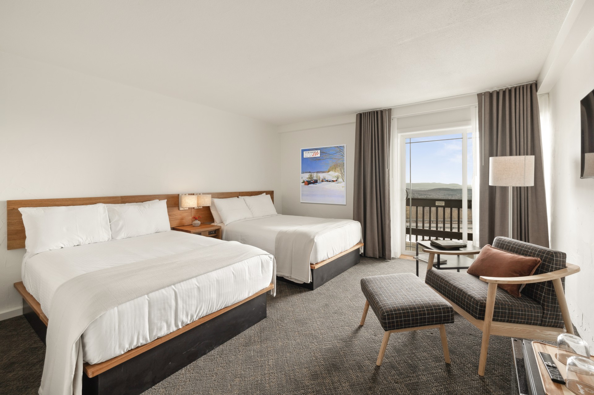 a room with two beds and a chair