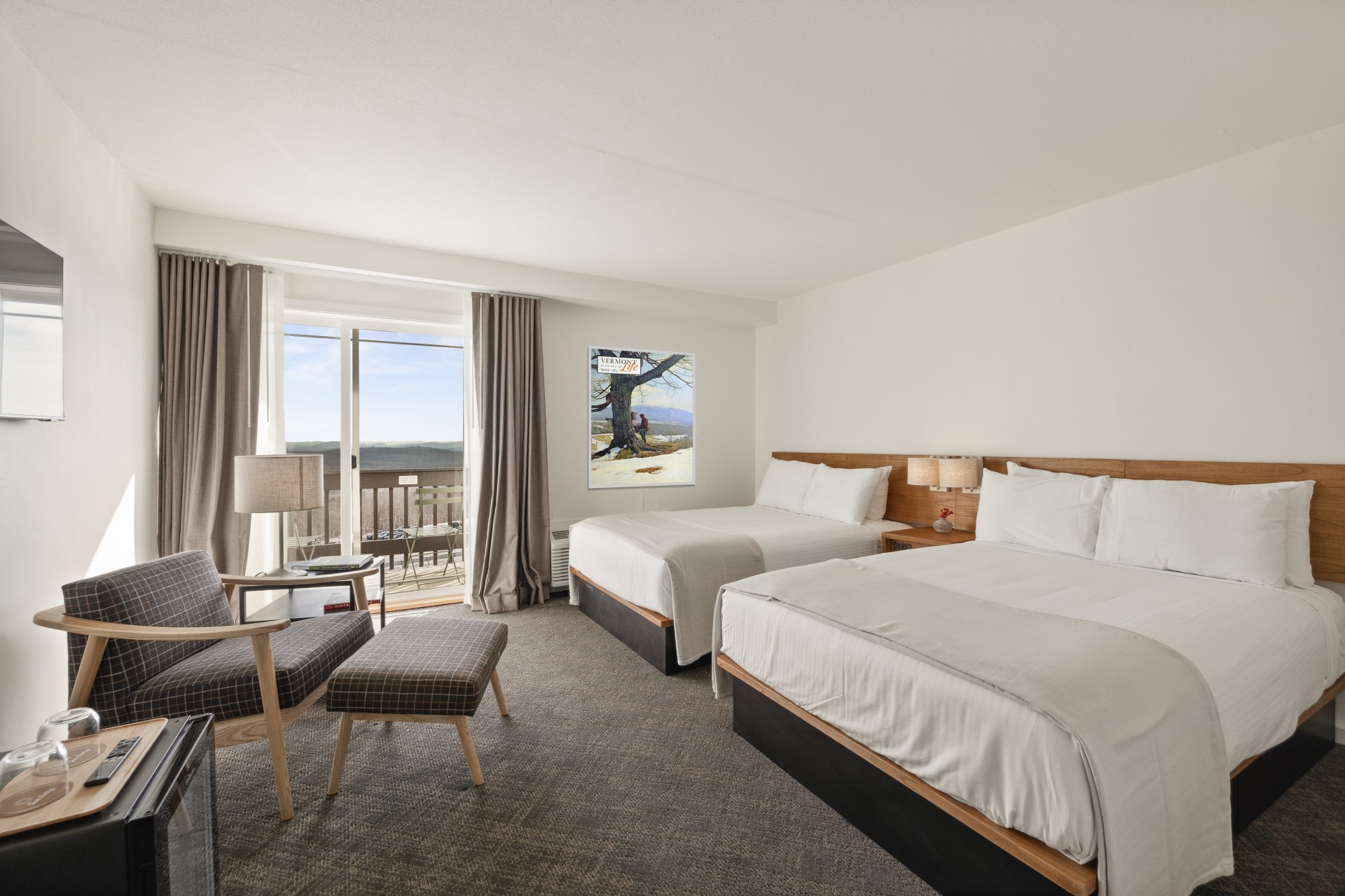 a room with two beds and a chair