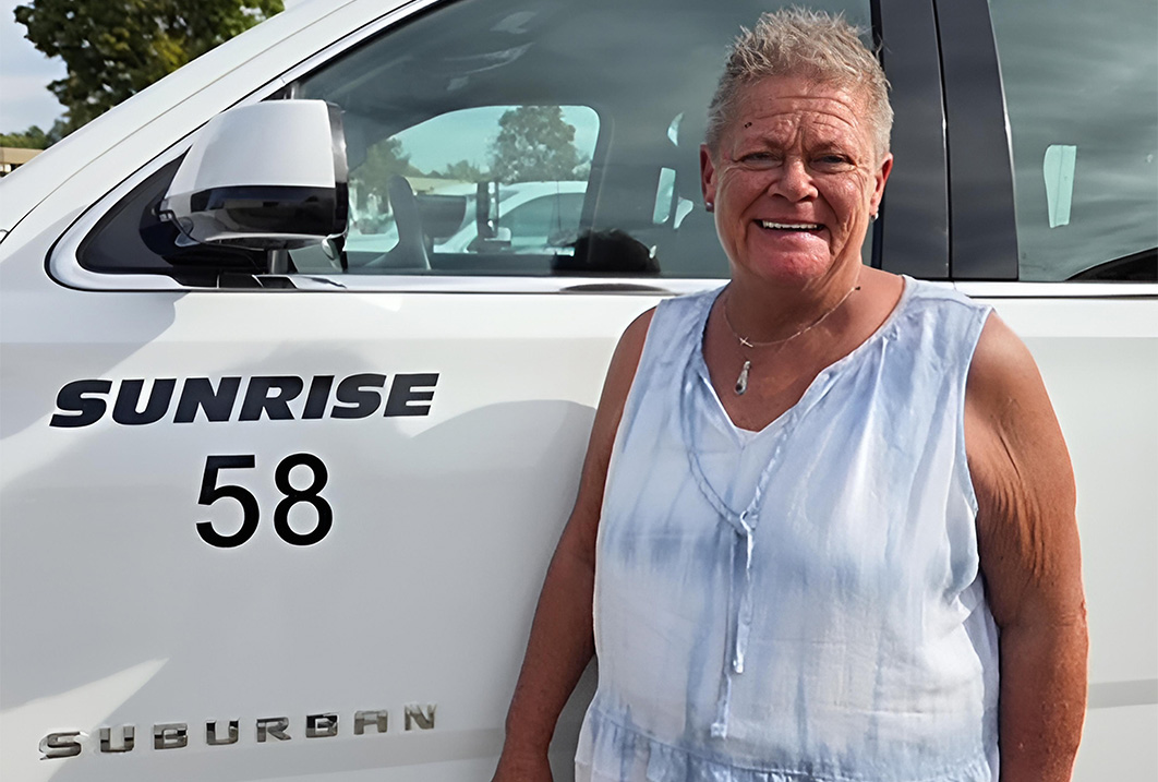 a woman standing next to a car