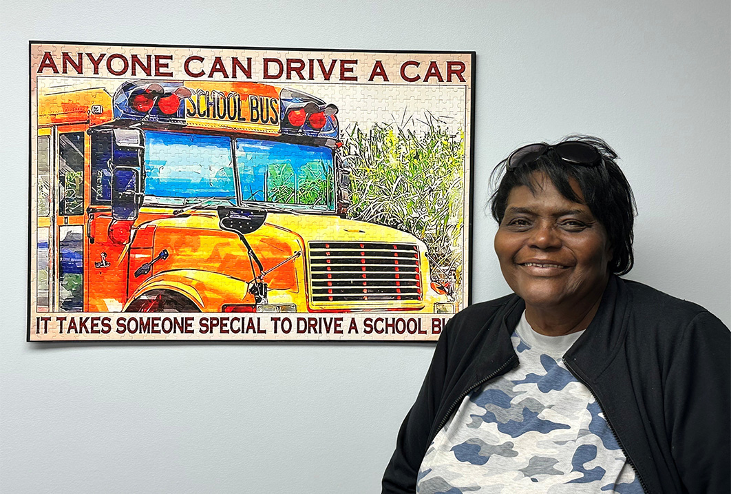 a woman smiling in front of a poster