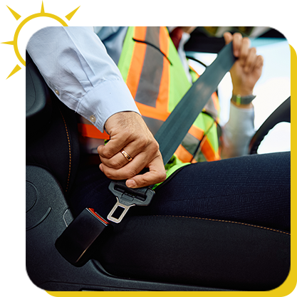 a person in a safety vest fastening a seat belt