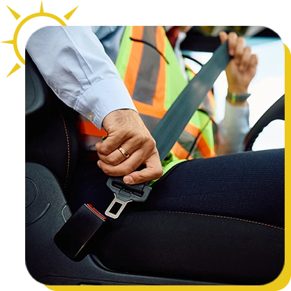 a person in a safety vest fastening a seat belt