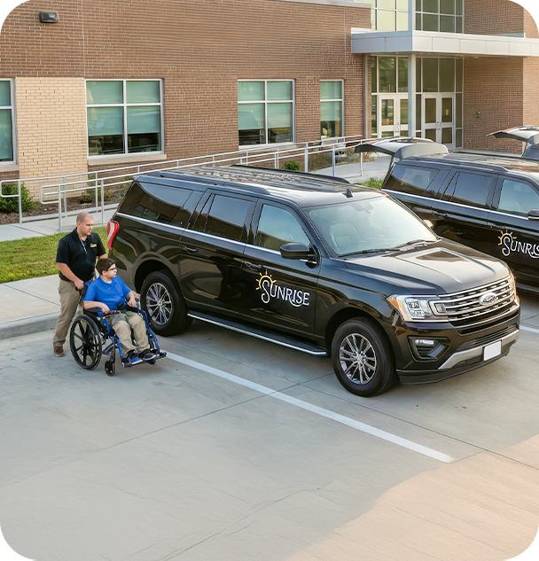 a man in a wheelchair next to a black van