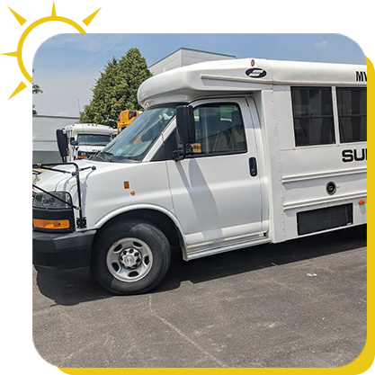 a white bus parked in a parking lot