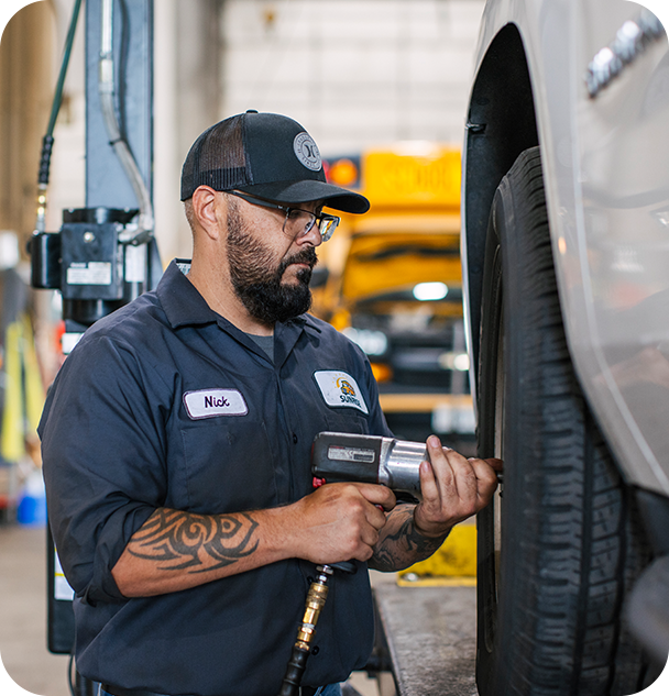 a man using a drill to fix a tire