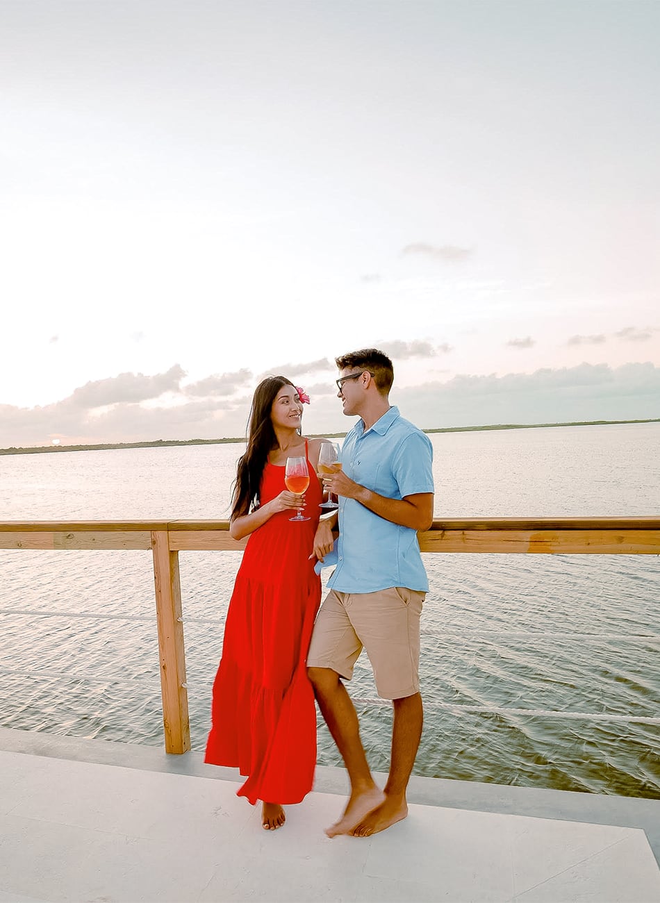 a man and woman holding wine glasses