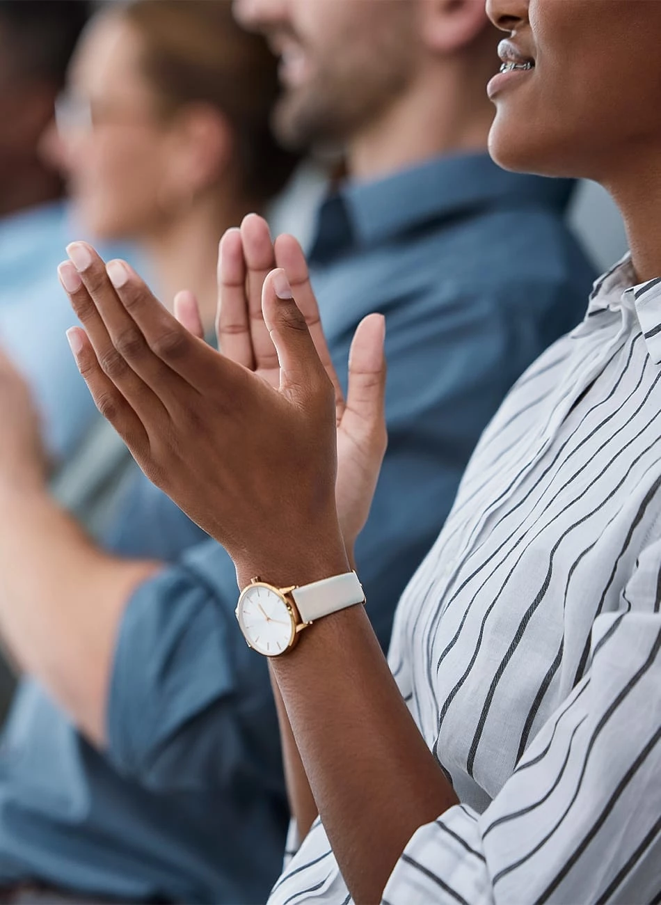 a close-up of people clapping