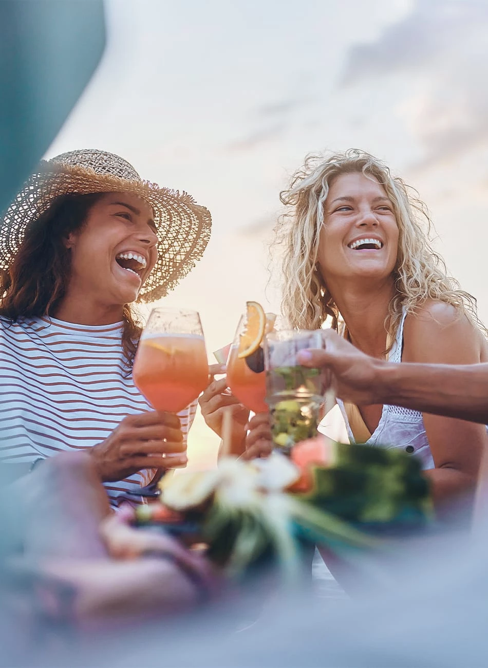 a couple of women holding glasses of wine