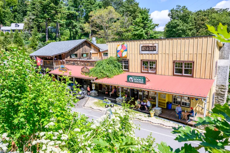 a building with many shops and trees