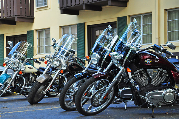 a row of motorcycles parked in front of a building