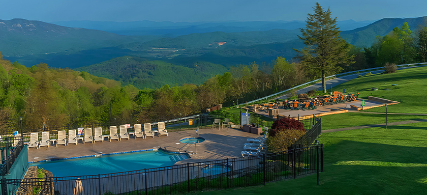 a pool and a slide overlooking a valley
