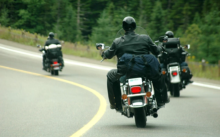 a group of people riding motorcycles