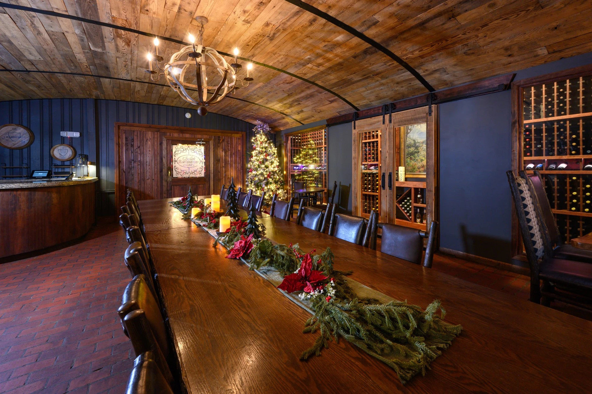 a long table with a candle and a christmas tree in the background