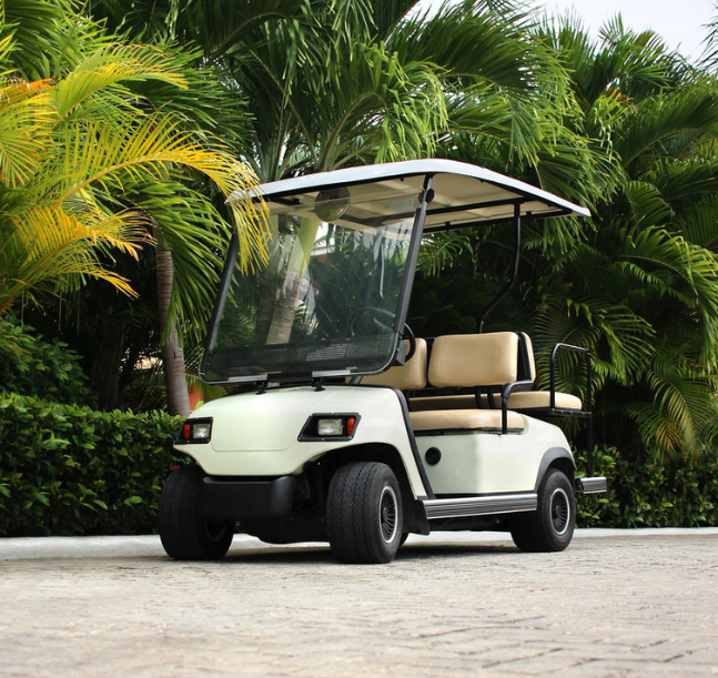 a golf cart parked on a brick road
